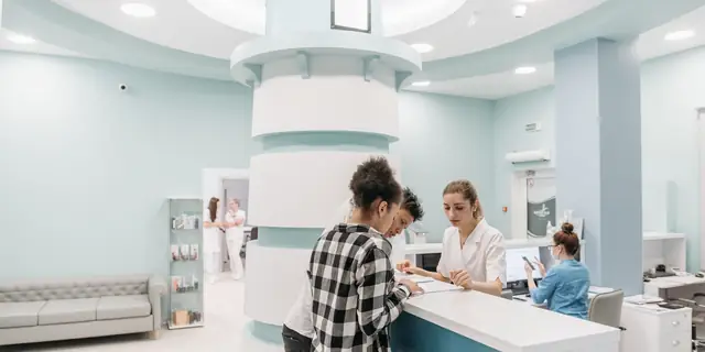 Patients at a clinic's front desk.